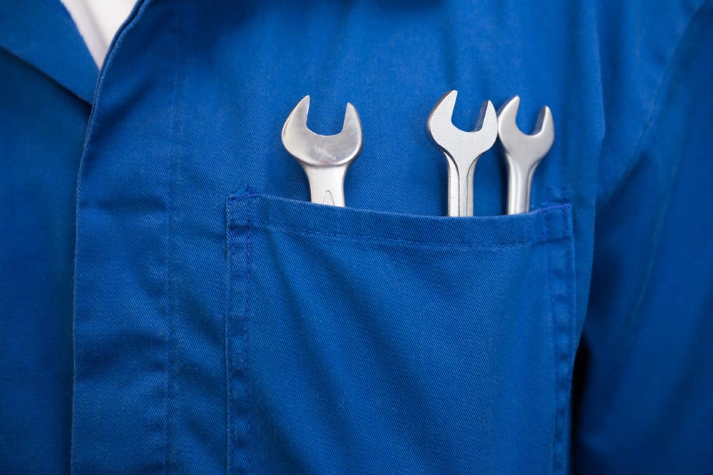 Mechanic with wrenches in pocket at the repair garage